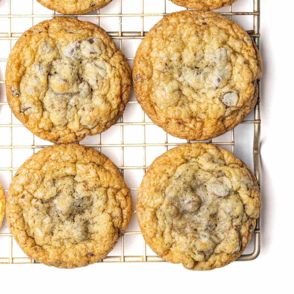Chocolate chip cookies on a wire rack.