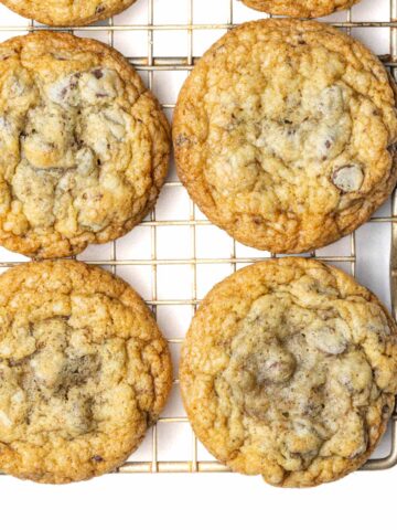 Chocolate chip cookies on a wire rack.