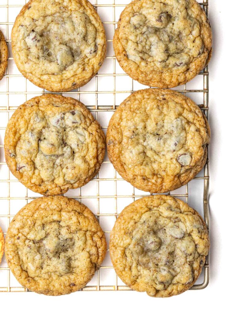 Chocolate chip cookies on a wire rack.