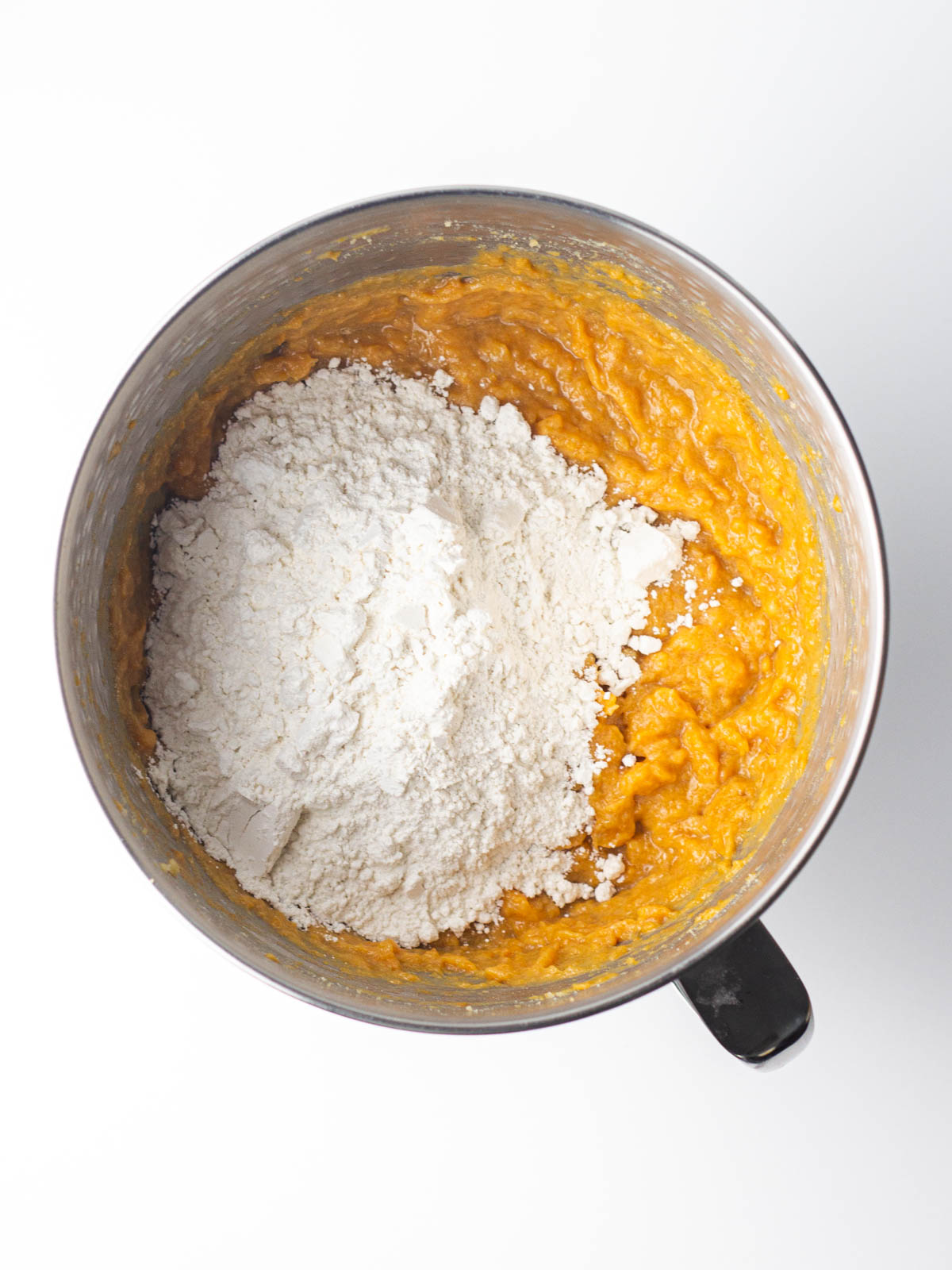 Flour and dry ingredients added to the sweet potato cake batter.