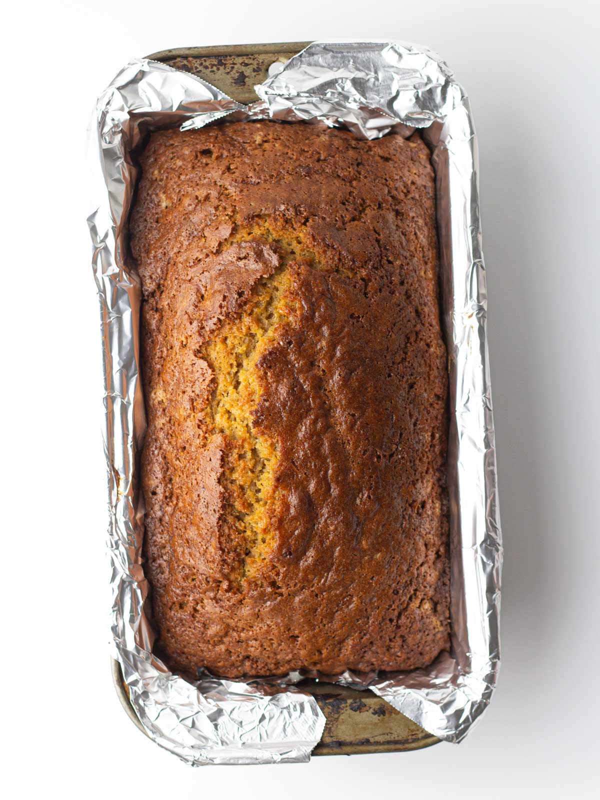 Baked chai bread in the foil lined metal loaf pan.