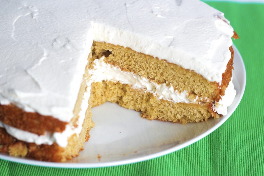 two layers of Irish Coffee Cake separated by and topped with homemade bailey's whipped cream.
