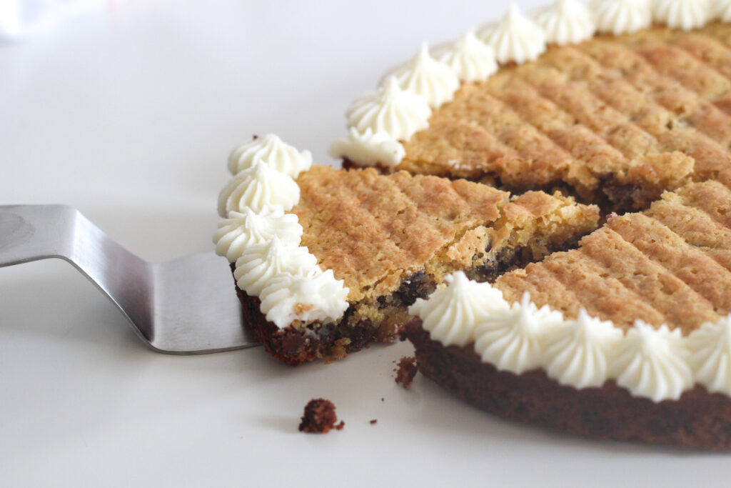 Slice of passover chocolate chip cookie cake slightly removed from the rest of the cake.
