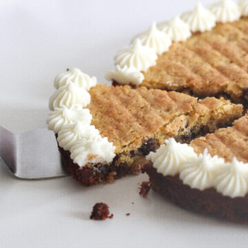 Slice of passover chocolate chip cookie cake slightly removed from the rest of the cake.