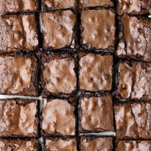 A close up of a batch of brownies cut into squares showing slight separation between some of the squares.
