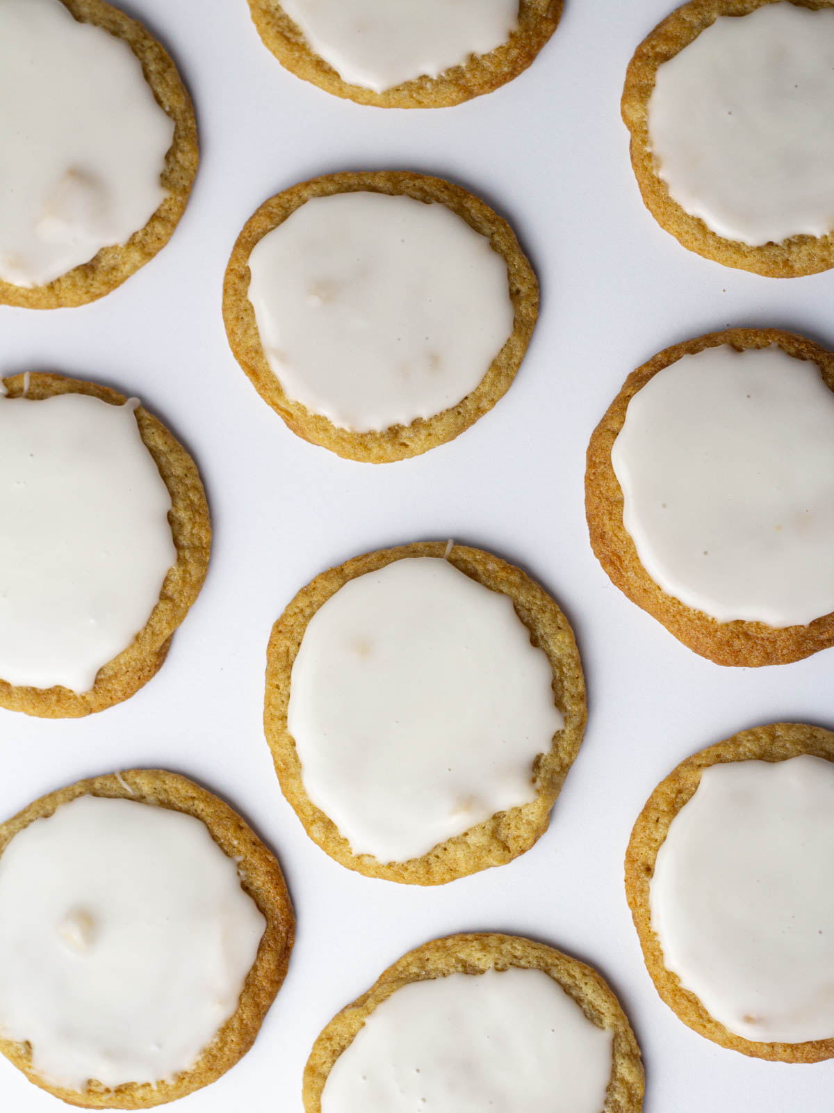 Iced beer cookies spread around a white surface.