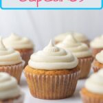 A Pinterest pin of a cinnamon cupcake in the center of the frame surrounded by blurred cupcakes.