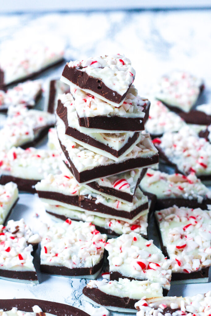 a stack of salted peppermint bark surrounded by layers of salted peppermint bark