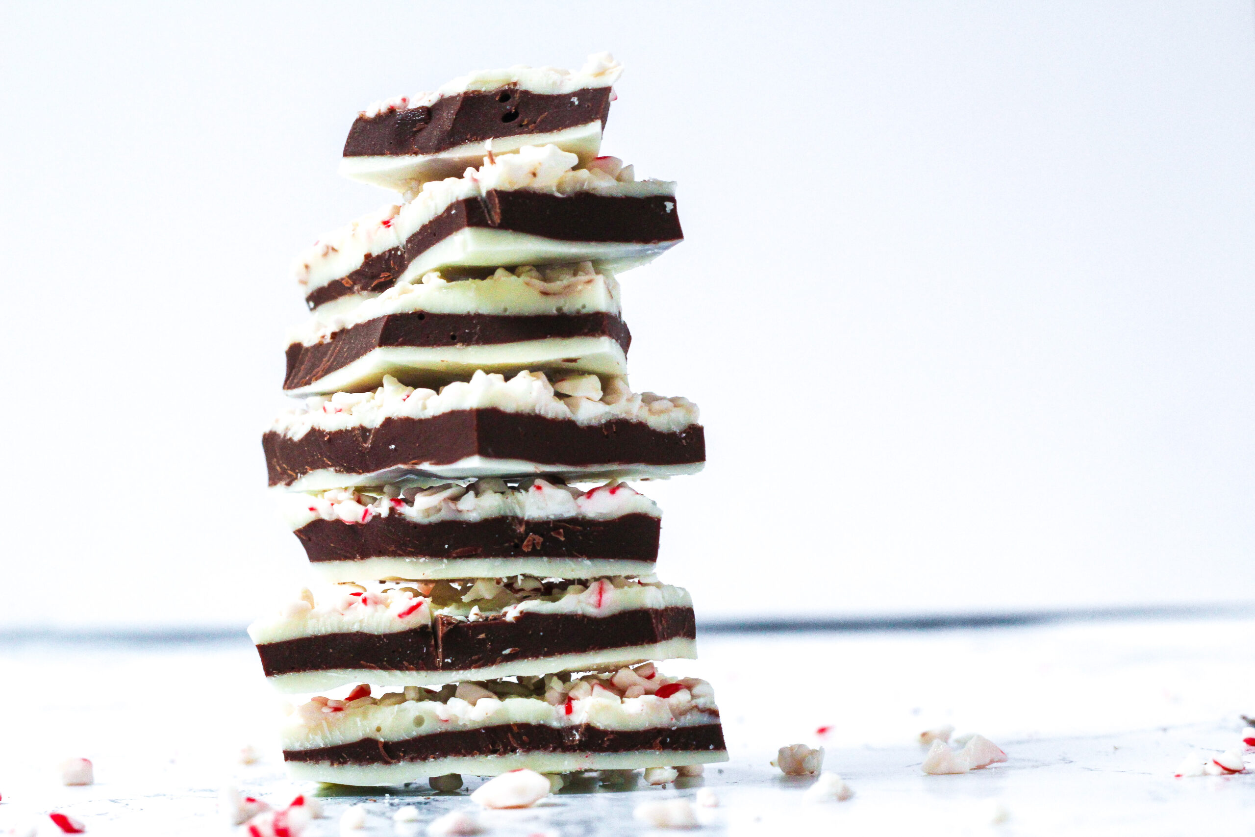 stack of 7 pieces of salted peppermint bark surrounded by pieces of crushed candy cane