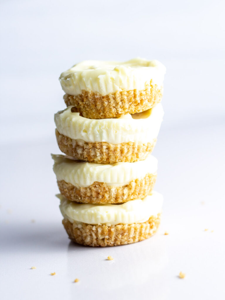 A side view of a stack of four prosecco cheesecakes.