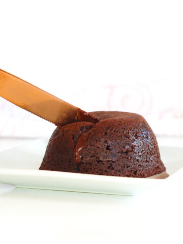 a knife cutting a single-serving luxurious red wine molten chocolate lava cake