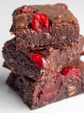 A stack of three extra fudgy chocolate cherry brownies.