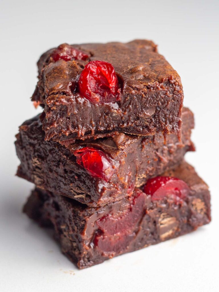 A stack of three extra fudgy chocolate cherry brownies.