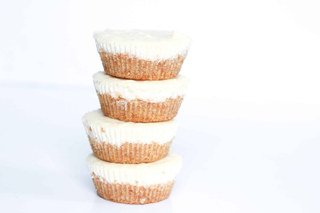 stack of four southern cocktail inspired mini milk punch mardis gras cheesecakes.
