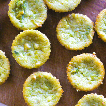 Close up top down view of avocado cheesecakes on a wooden cutting board