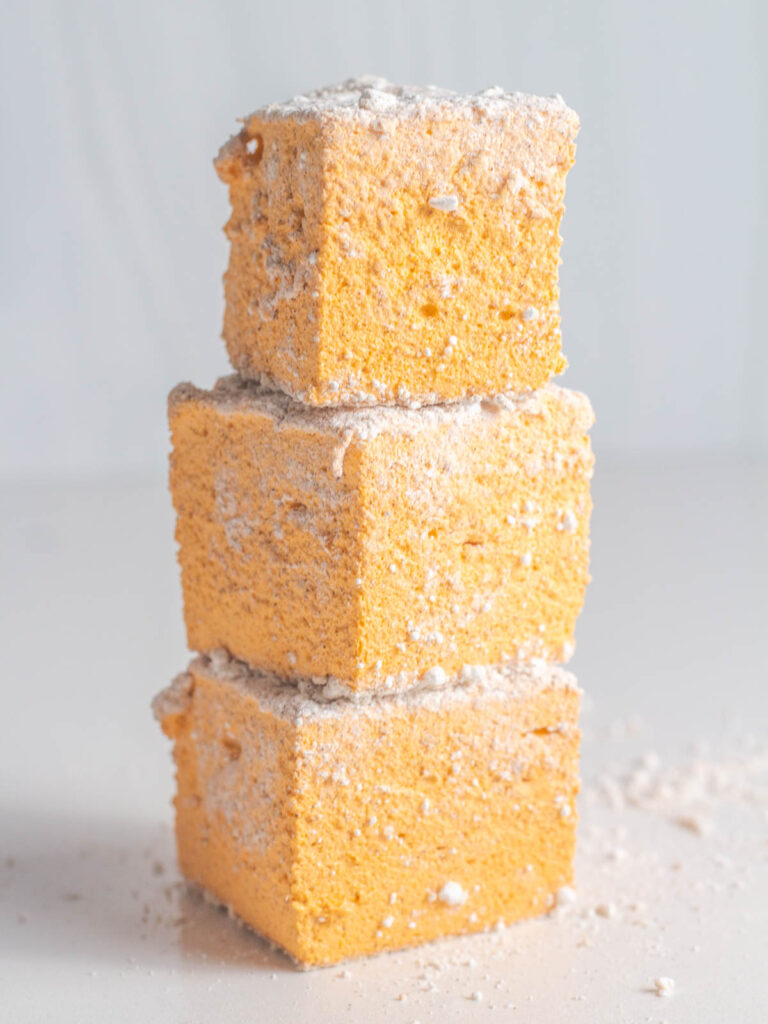 A stack of 3 orange pumpkin spice marshmallows.