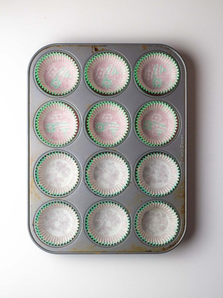 A 12-cup muffin tin lined with paper liners.