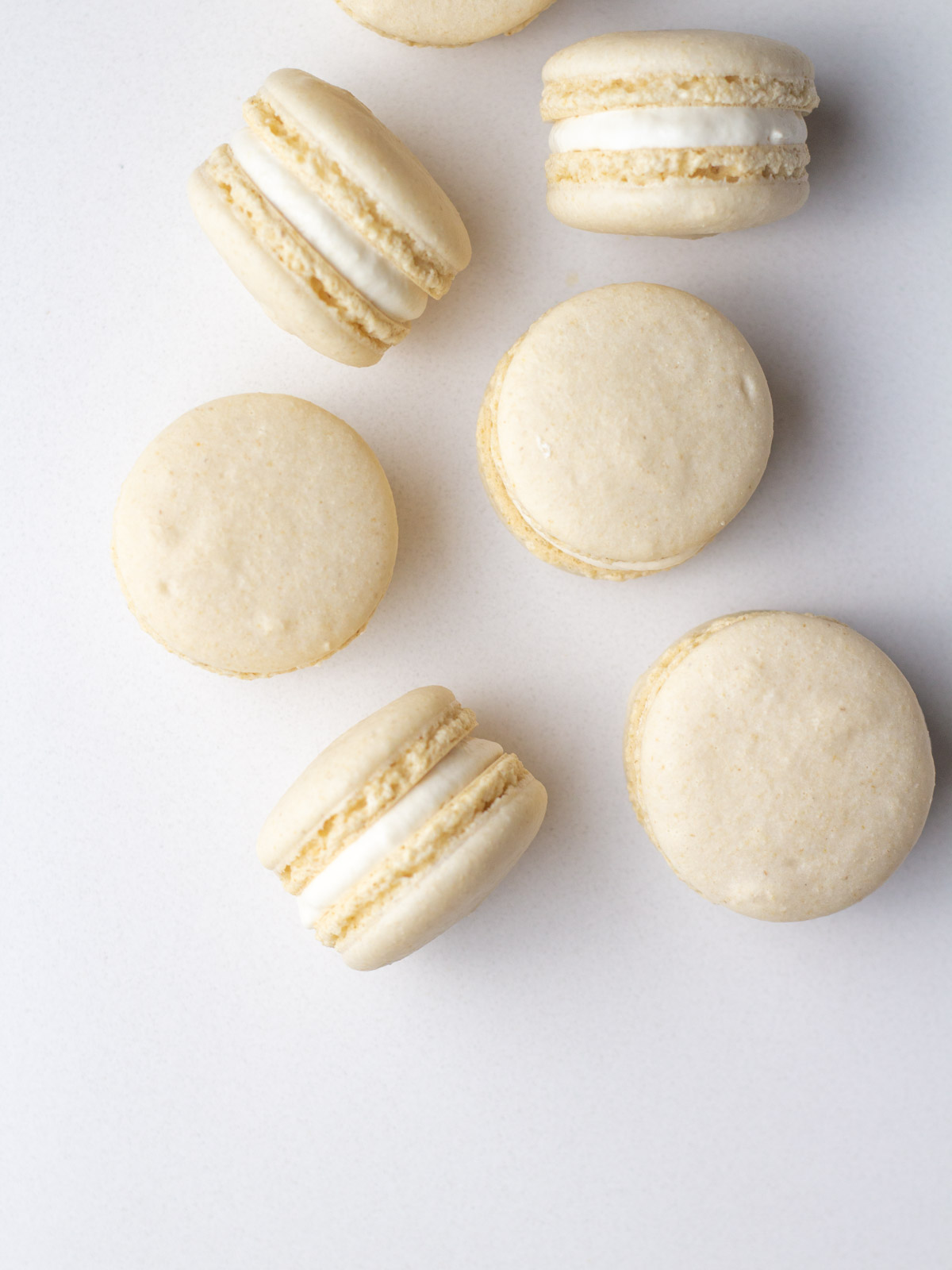 Nut-free oat flour macarons coming into the frame from the top right corner, some on their sides.