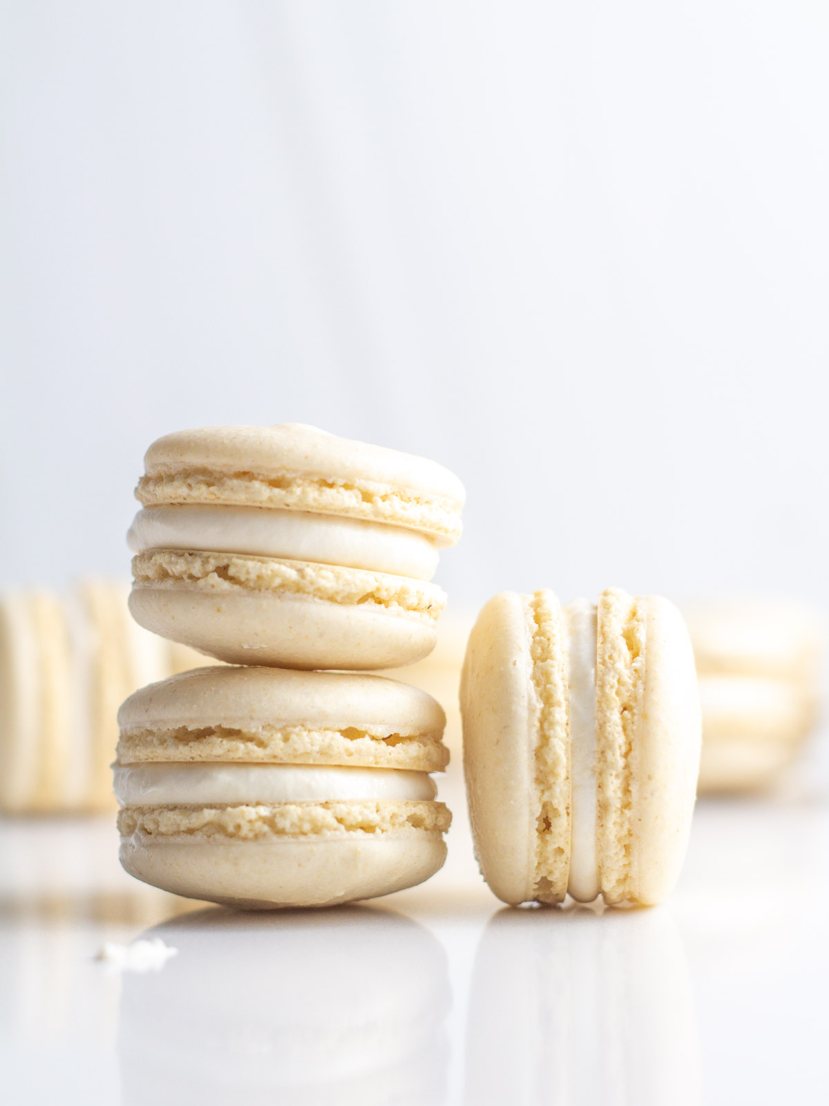 Close up of two oat flour macarons stacked with another on its side next to the stack.