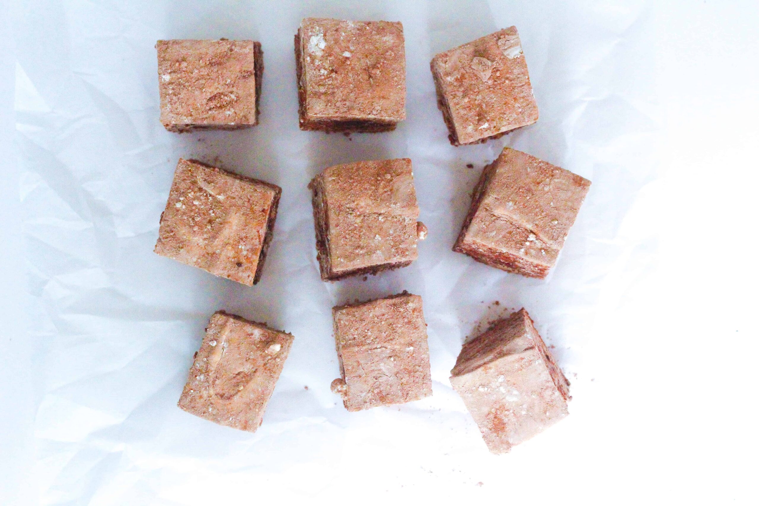 top down view of a three by three grid of coffee marshmallows, some of which are off kilter