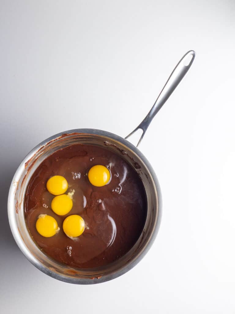 Eggs added to the chocolate mixture in the sauce pan.