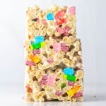 A straight-on side view of a stack of three lucky charms treats.