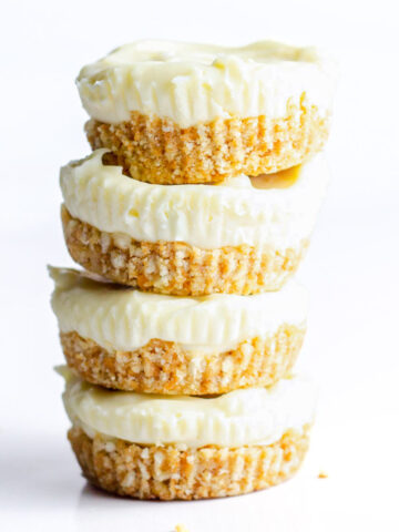 A side view of a stack of four prosecco cheesecakes.