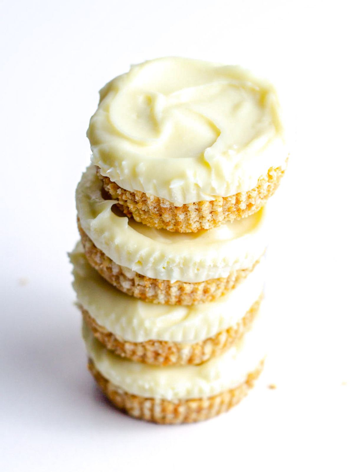A top down angled view of a stack of four prosecco cheesecakes.
