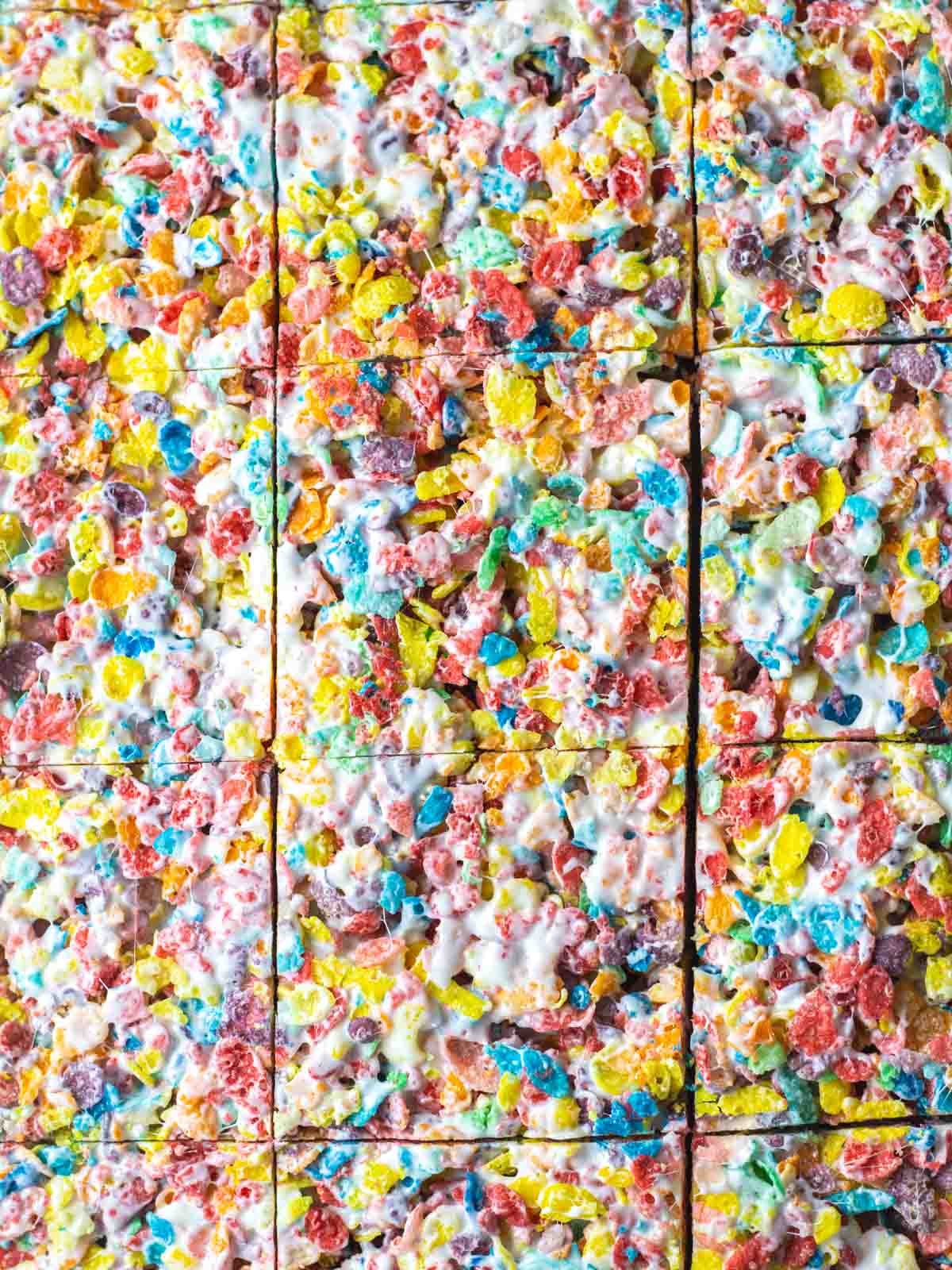 Close up of the dish of Fruity Pebbles treats in the baking dish with knife cuts creating squares.