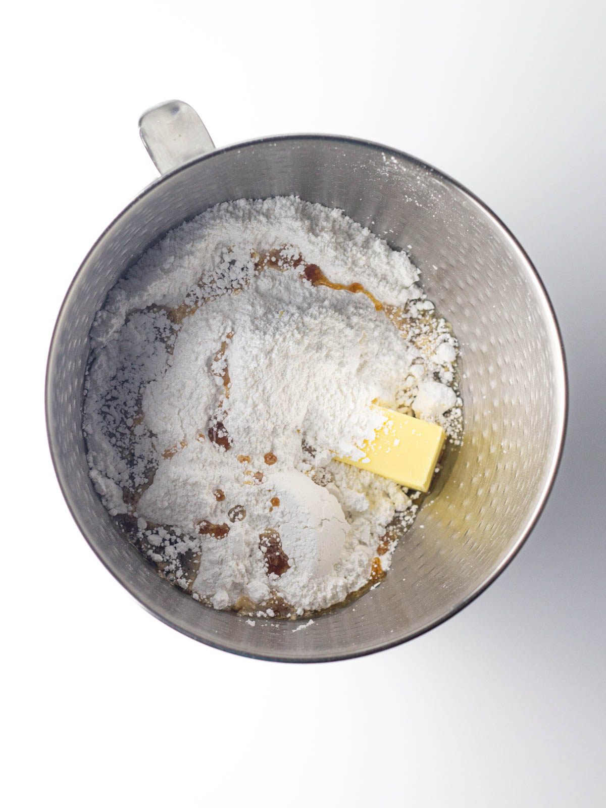Maple buttercream frosting ingredients in a silver textured mixing bowl.