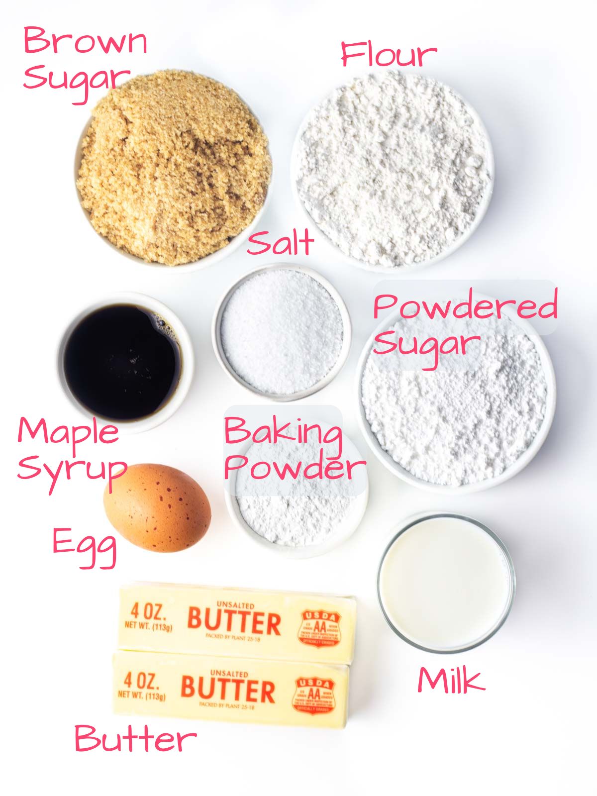 Ingredients needed to make Maple Cupcakes on a white surface.