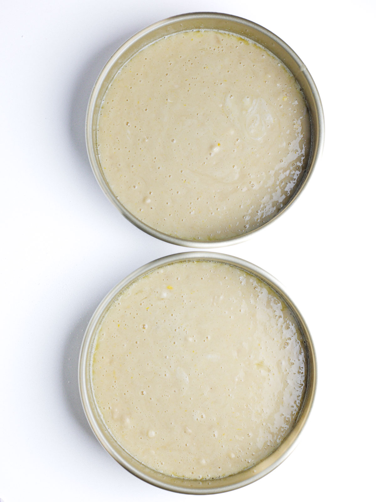 Champagne cake batter in two 9" cake pans.