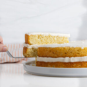 A slice of champagne cake being removed from the rest of the cake.