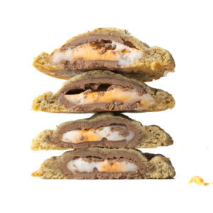 A stack of four halves of Creme Egg Cookies showing the gooey creme egg centers.