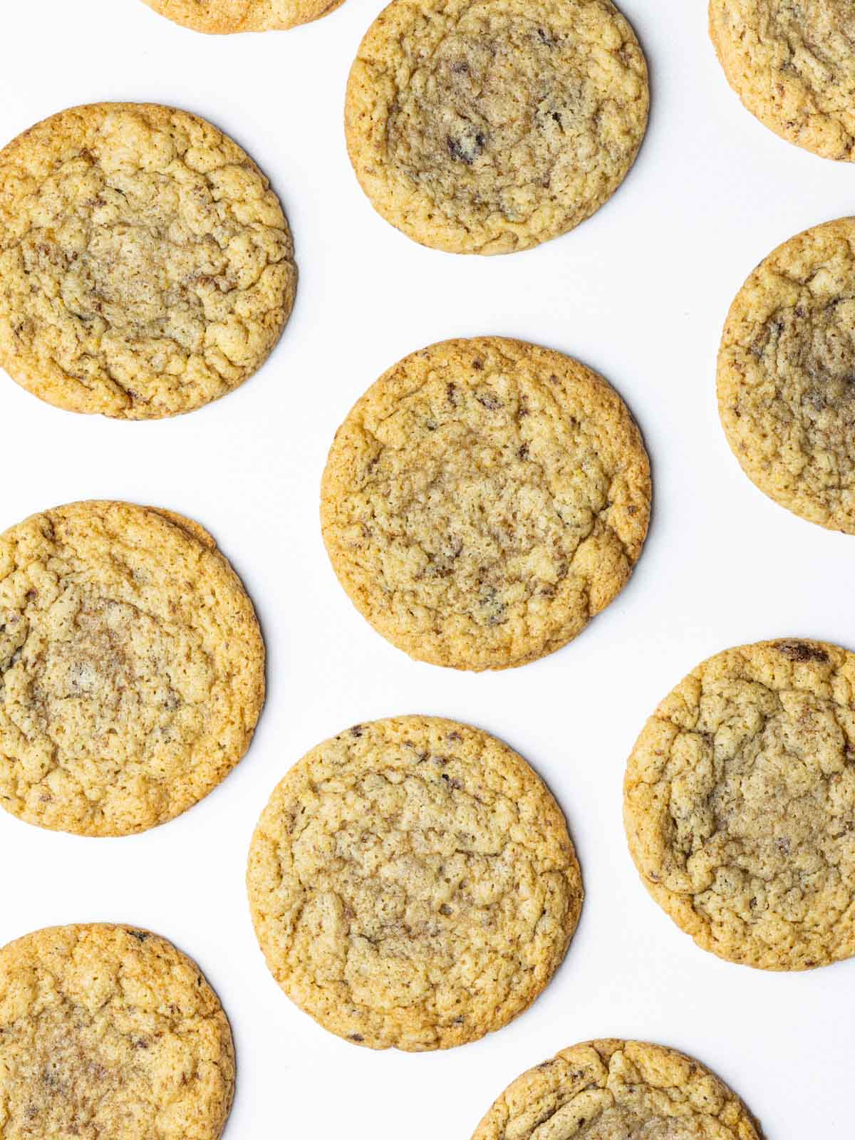 a batch of chocolate chipless cookies on a white surface.