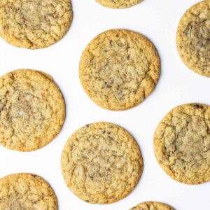 A top down view of a batch of chocolate chipless cookies on a white surface.