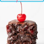 A pin for Pinterest of a stack of three fudgy chocolate cherry brownies with a maraschino cherry on top.
